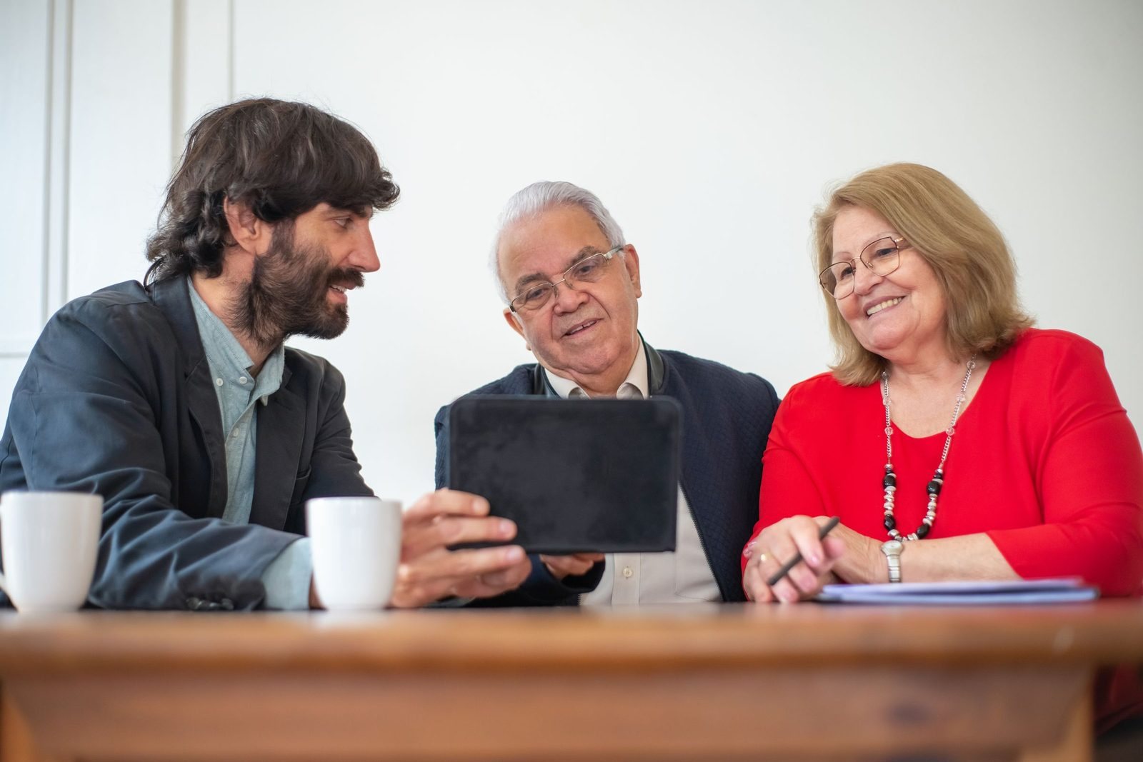 An adviser with a client couple at a table