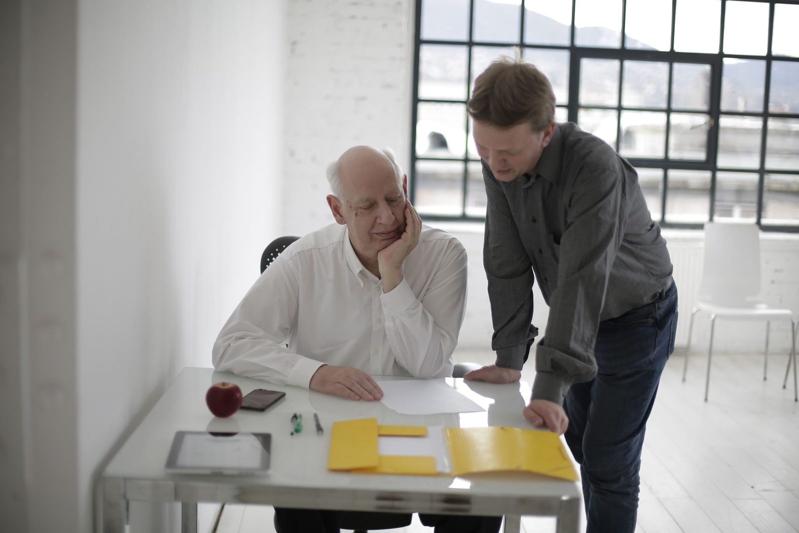 A trainee adviser going through a client file with the firm's principal