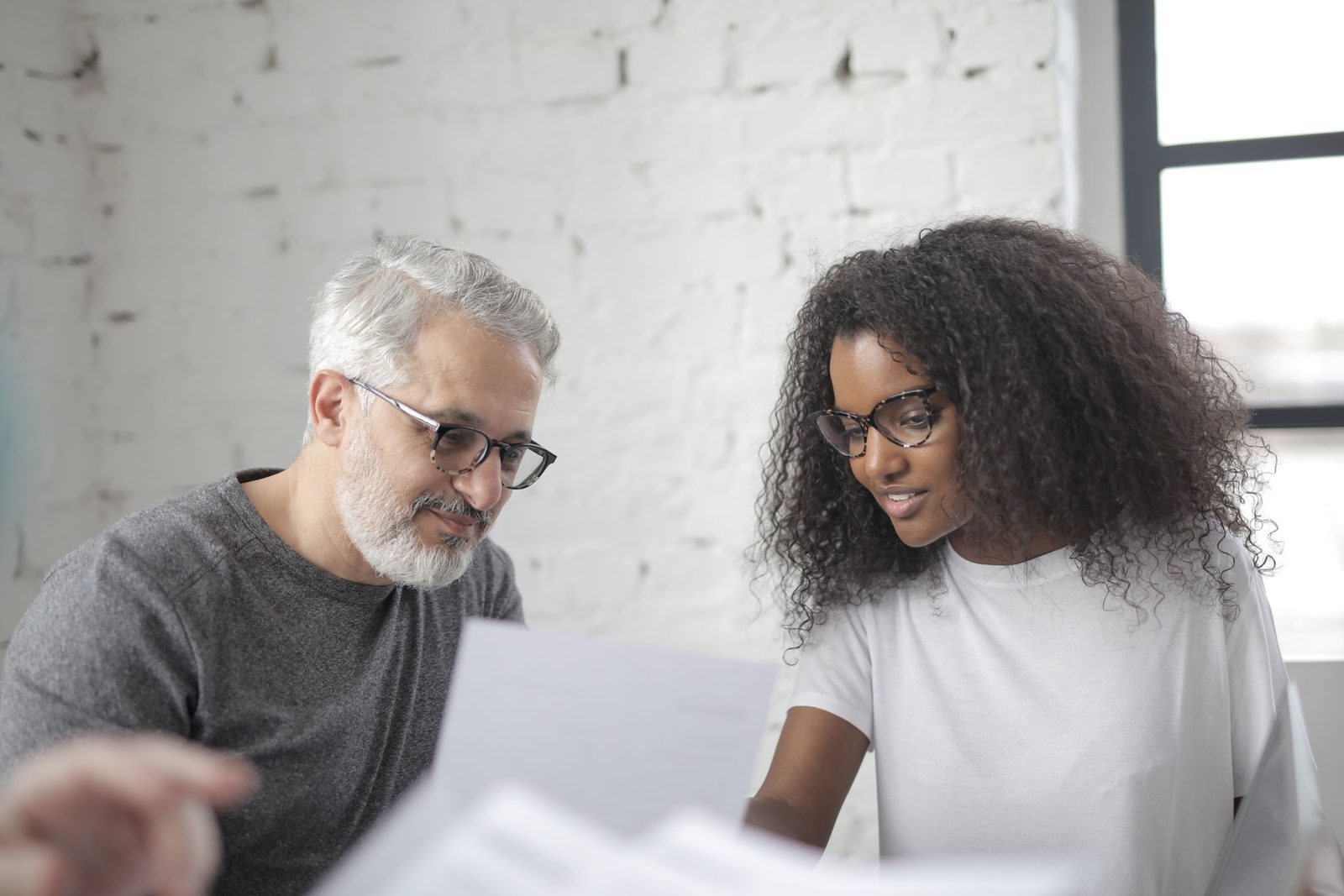 A principal and a colleague reading papers