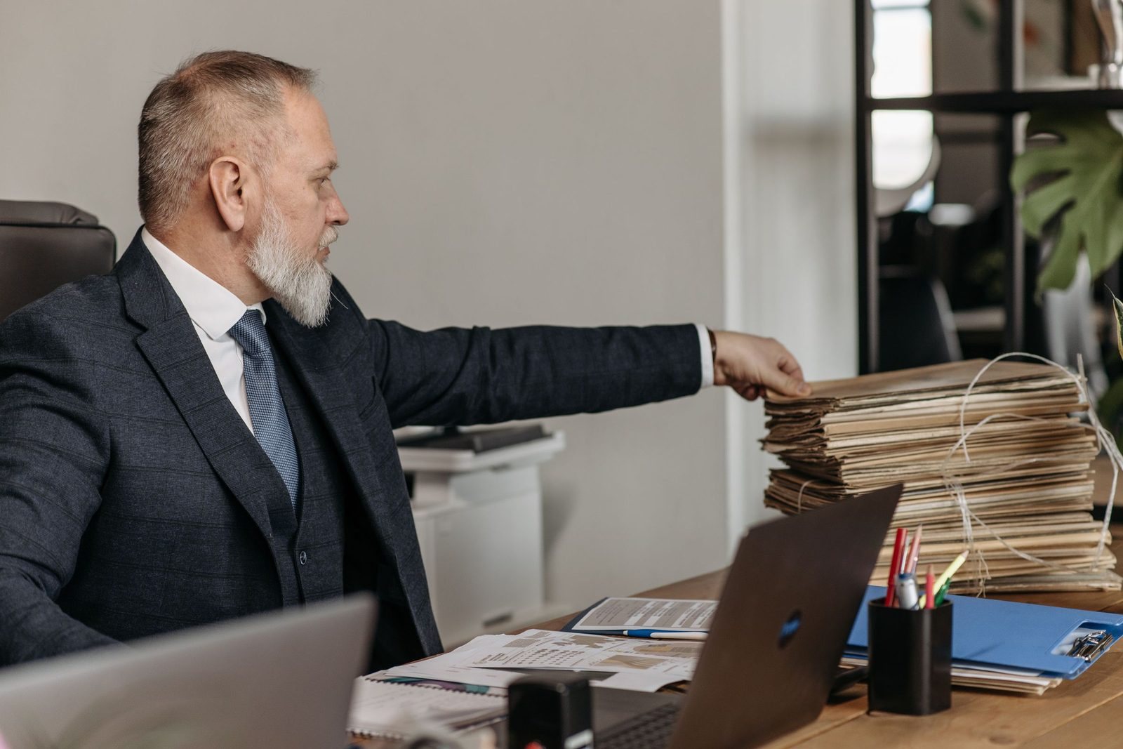 A principal reaching for a client file